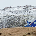 Icelandic landscape with  blue chalet house in winter